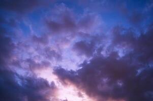 Twilight, sunset sky, clouds in the evening at dusk with blue, purple, light. photo