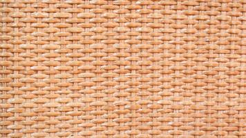 brown background with wavy rattan texture. The background of a wicker basket. photo
