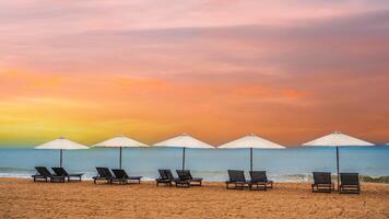 Panoramic Scenic view of the sandy beach with umbrellas and sun beds on the coastline. photo