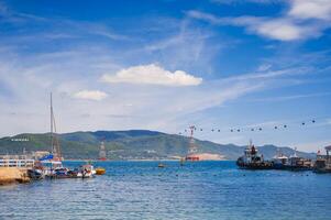 A landscape with Vietnamese boats in the sea and a view of the island of Vinperl. photo