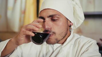 Sad Chef In Uniform Drinks Homemade Red Wine And Says It Is Good photo