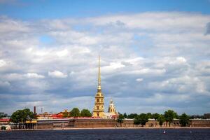 A picturesque view of the Peter and Paul Fortress in St Petersburg, Russia, with the iconic golden spire of Peter and Paul Cathedral. photo