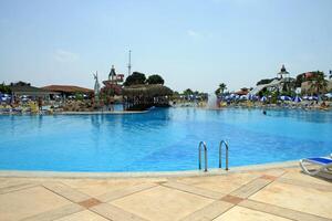 Luxurious resort pool with bridge and water slides. photo