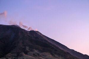 Eruption of Stromboli volcano at dusk. photo