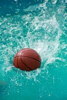 The ball falls into the turquoise water of the pool, creating spectacular splashes and drops. photo