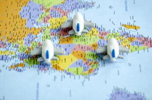 Close up view of small toy airplanes placed on a world map representing travel or global exploration. Travel and destination concept photo