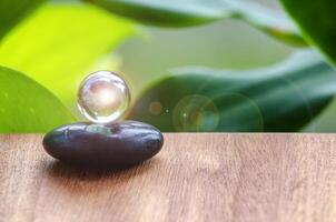 Black Zen stone with customizable space for text or message. Shining glass marble background photo