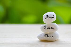 Find Inner Peace text on the white Zen stones. Inner peace concept photo