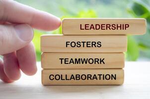 Leadership fosters teamwork and collaboration text on wooden blocks. Leadership concept photo