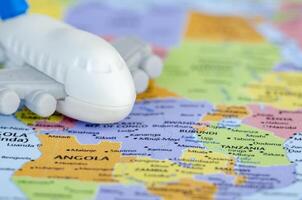 Close up of small toy airplane placed on a world map representing travel or global exploration. Travel and destination concept photo