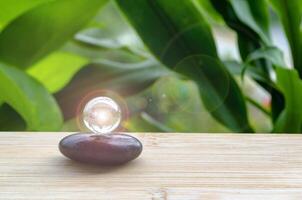 Black Zen stone with customizable space for text or message. Shining glass marble background. photo