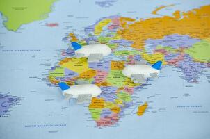 Top view of small toy airplanes placed on a world map representing travel or global exploration. Travel and destination concept photo