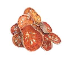 Dried sliced bael fruits isolated on white background. Concept, Herbal drink ingredient with medicinal property to boiled as tea or beverage. Good for health. photo