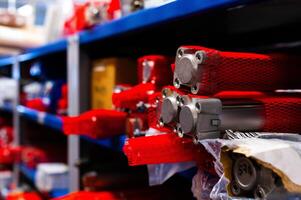 Crates and boxes on shelves in a warehouse. Close-up of machine parts for a factory photo