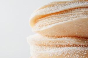 A close up of a stack of white frosting photo