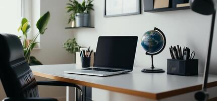 Modern Workspace with Laptop and Globe photo