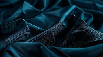 Deep teal fabric drapes in elegant folds photo
