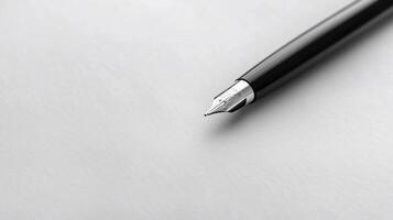 Close-up of a fountain pen on white paper. Fine nib detail photo