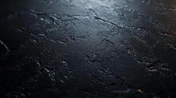 A black surface with some scratches and dirt photo