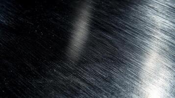 Dark, brushed metal surface with light reflections photo