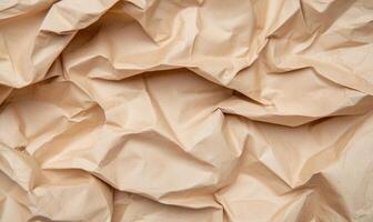 Crumpled paper background with a light brown color photo