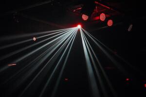 Stage lights illuminating the night. Powerful beams of light create a dramatic effect photo