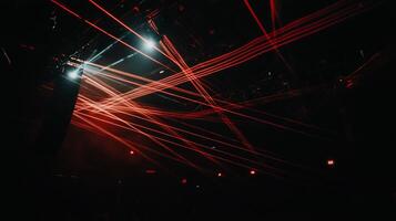 Laser beams crisscrossing a dark stage photo