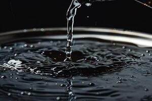 Water pouring into a bowl, creating ripples and splashes photo