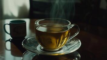 Steaming hot cup of tea on a table photo