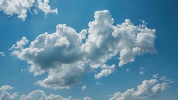Fluffy cumulus clouds against a vibrant blue sky. Clusters of white puffy clouds fill the image, contrasting beautifully with the clear azure sky. Sunlit areas highlight the texture of the clouds photo