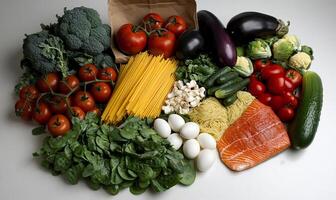 Fresh, colorful assortment of healthy foods. Various vegetables, fruits, eggs, pasta, and fish displayed photo