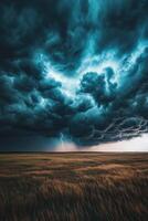 Dramatic clouds swirl over an open field photo
