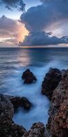 Sunset over rocky coastal landscape photo