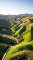Rolling green hills under bright blue sky photo