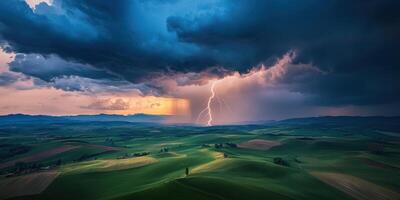 A lightning bolt strikes through the clouds over a green field photo
