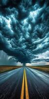 An empty road with storm clouds in the sky photo