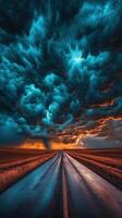 A long road with storm clouds in the sky photo