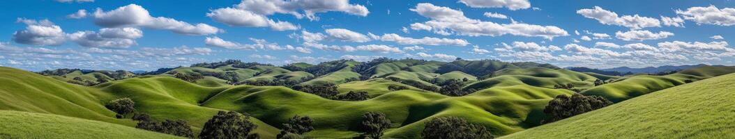 A green hill with clouds and trees photo