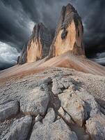 A rocky mountain with dark clouds in the background photo