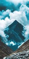 A mountain with a cloud covered sky photo