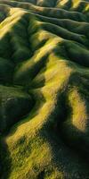 An aerial view of green hills and grass photo