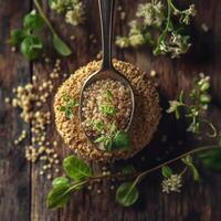Psyllium seed resting on a wooden surface with herbs photo