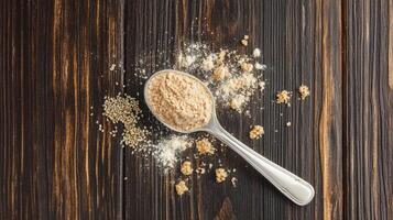 Psyllium husk powder on wooden table with spoon photo