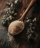 Psyllium husk displayed on wooden spoon with herbs photo