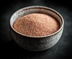 Psyllium husk in a decorative bowl on a dark surface photo