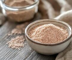 Raw psyllium husk powder in a ceramic bowl photo