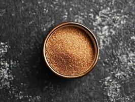 Psyllium husk in a brown bowl on a dark surface photo