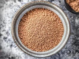 Psyllium husk in a rustic bowl on a textured surface photo