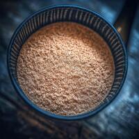 Psyllium husk in a bowl on a wooden surface photo
