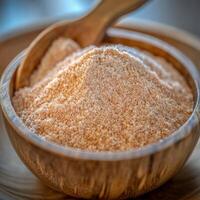 Psyllium husk powder in a wooden bowl on a table photo